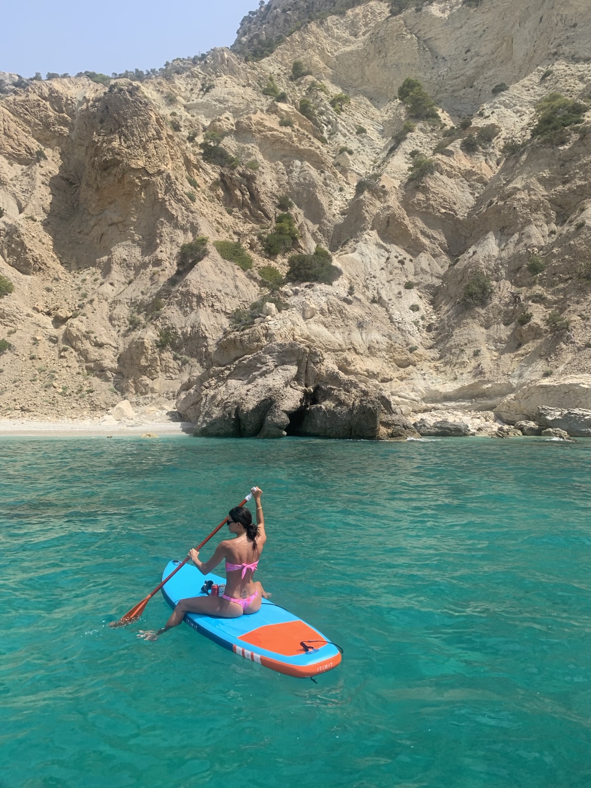 Paddleboarding in clear Balearic water