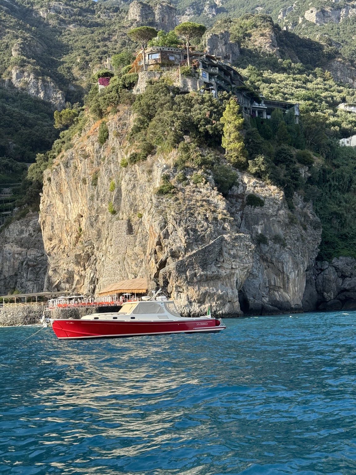 A red boat beneath the cliffs near Positano