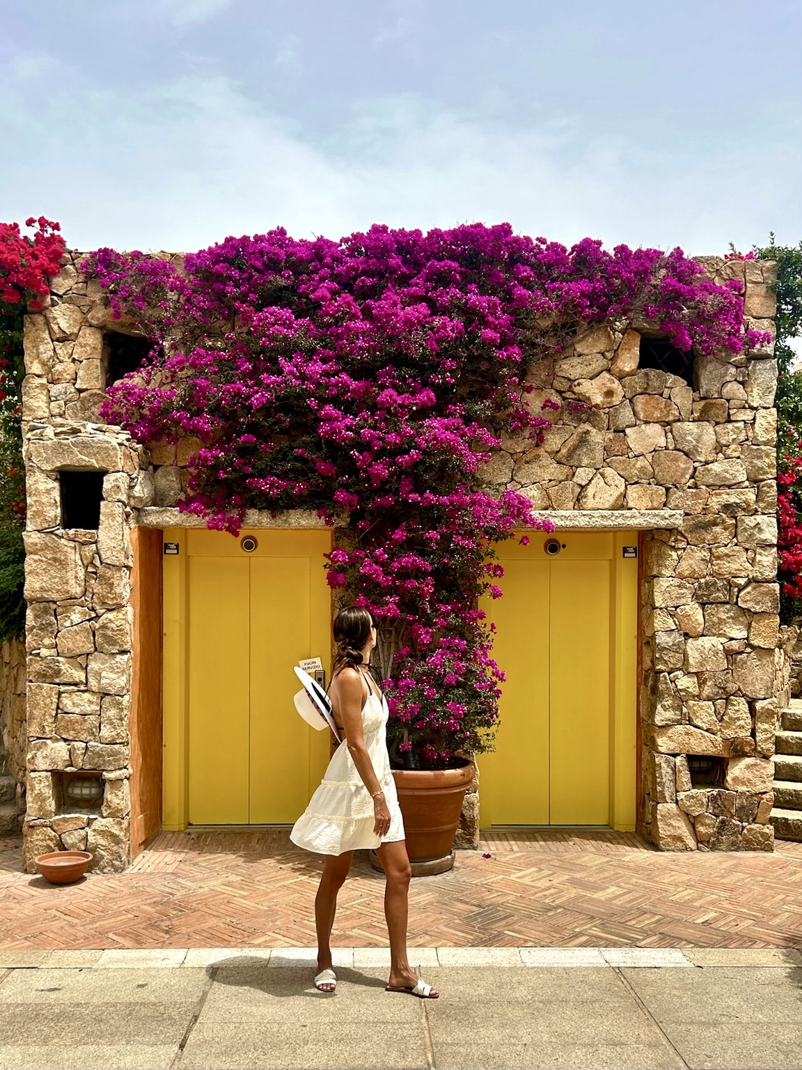 A flower-covered stone doorway in Puglia