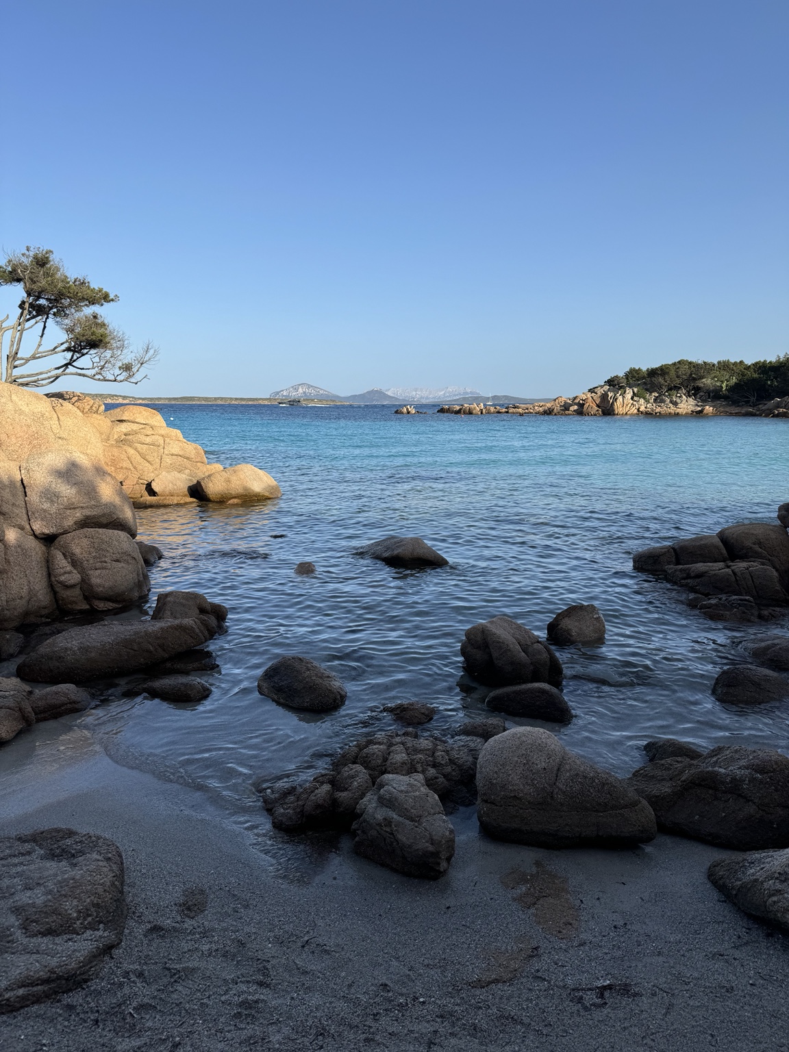 Granite rocks beside clear water in Sardinia